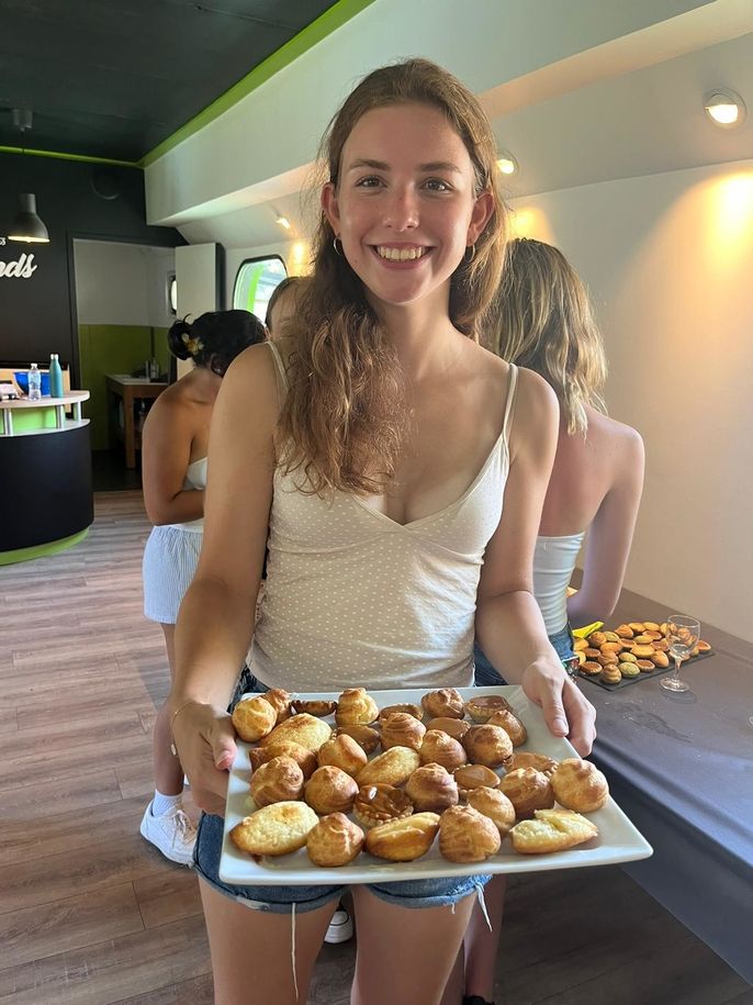 Student holding finished baked goods