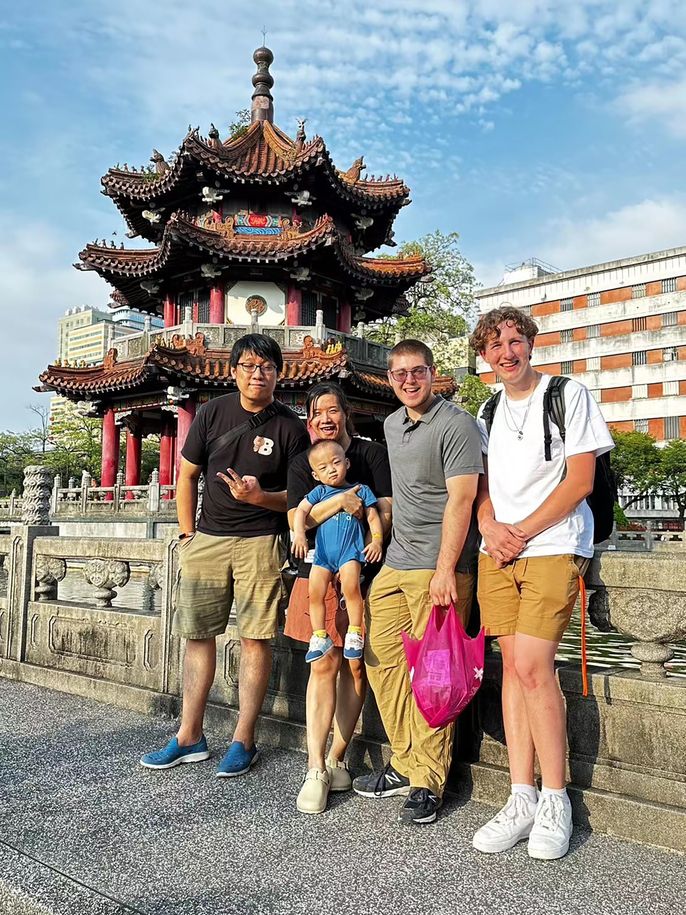 Host family and students in front of temple in Taipei