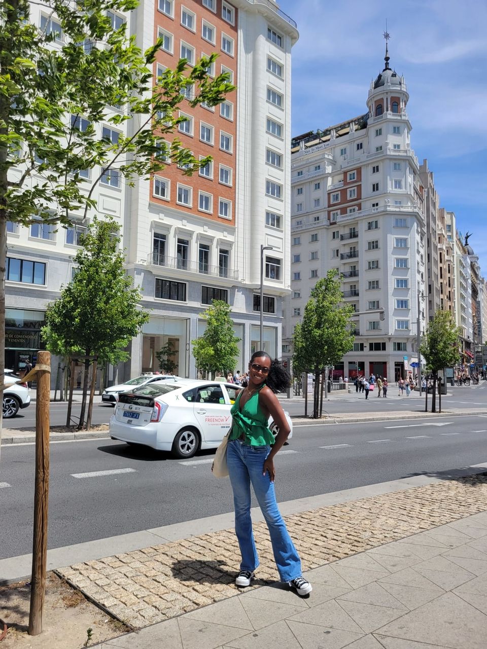 An image of a young black woman standing in front of a building in madrid 