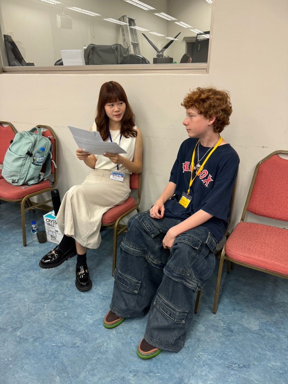 Student having a conversation with Chinese Language and Culture teacher.