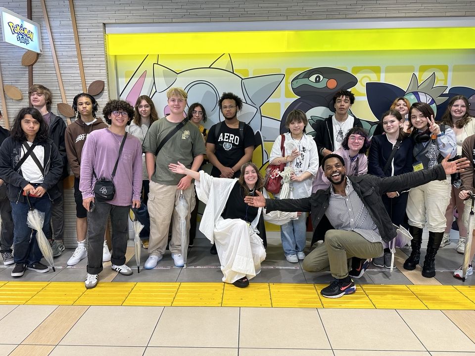 19 Global Navigators pose in front of the Pokemon Store at Tokyo Character Street.