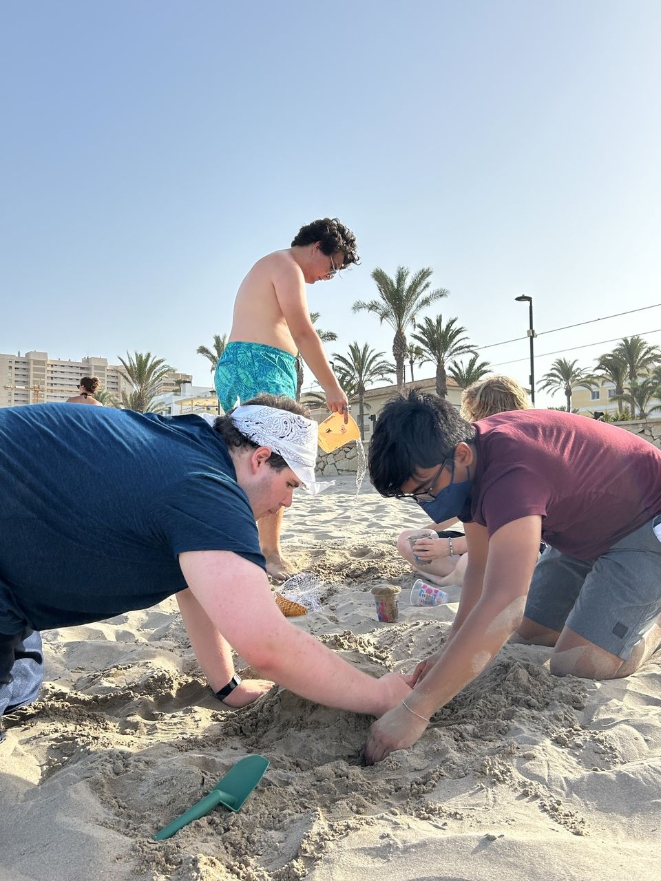 Starting to build the base of their sand castle!